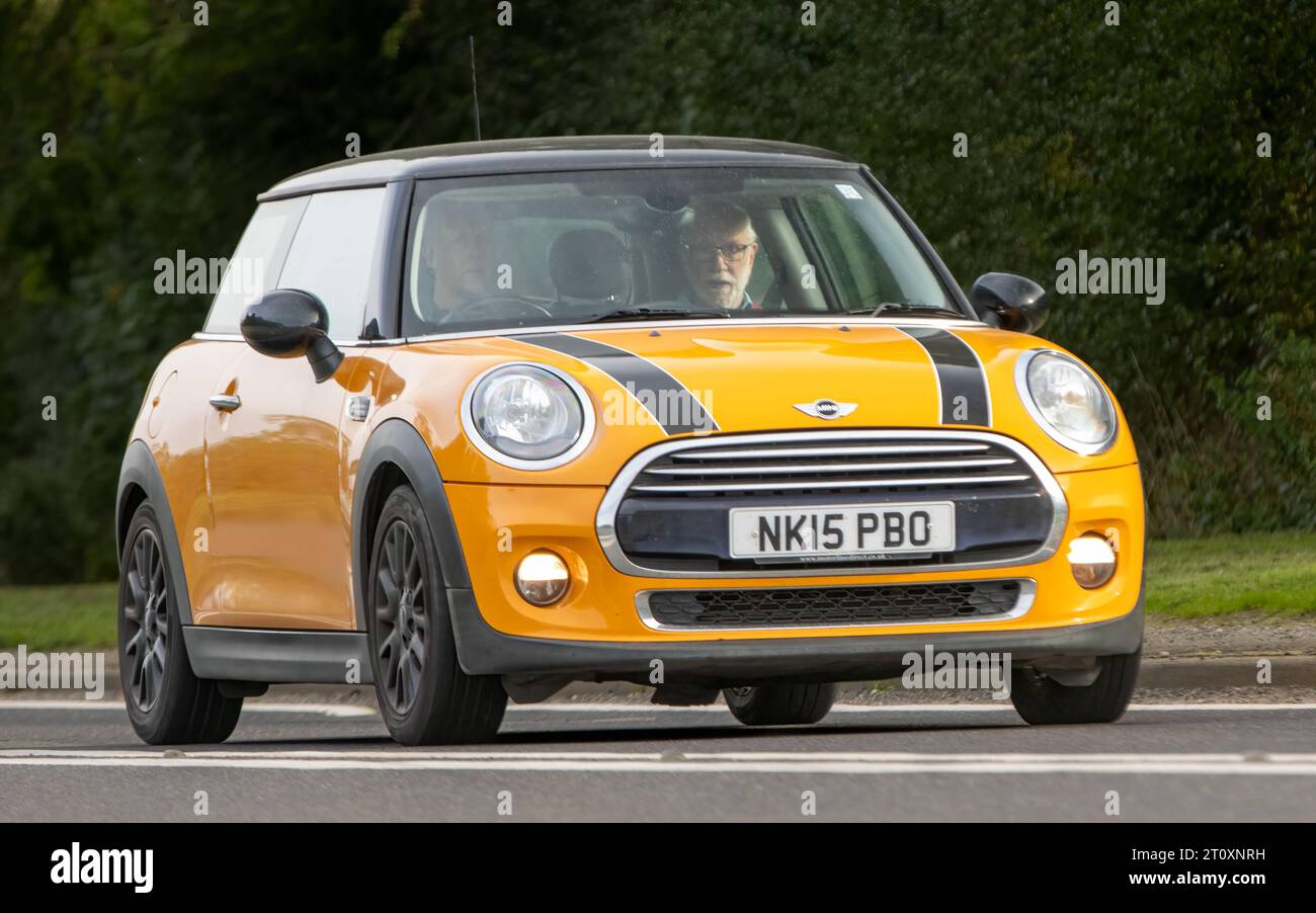 Bicester,Oxon.,UK - Oct 8th 2023: 2015 orange Mini Cooper classic car driving on an English country road. Stock Photo