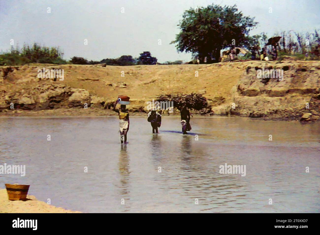 People on the banks of the White Volta river in northern Ghana, c.1959 Stock Photo