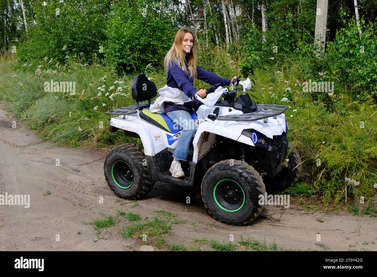 Happy girl on the ATV Quad Bike in the wood Stock Photo - Alamy