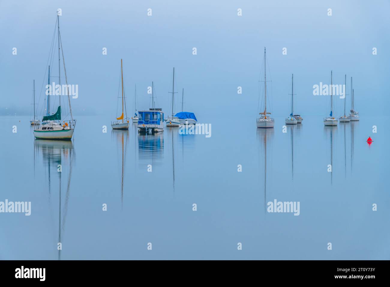 Foggy Sunrise with boats on Brisbane Water at Koolewong and Tascott on the Central Coast, NSW, Australia. Stock Photo