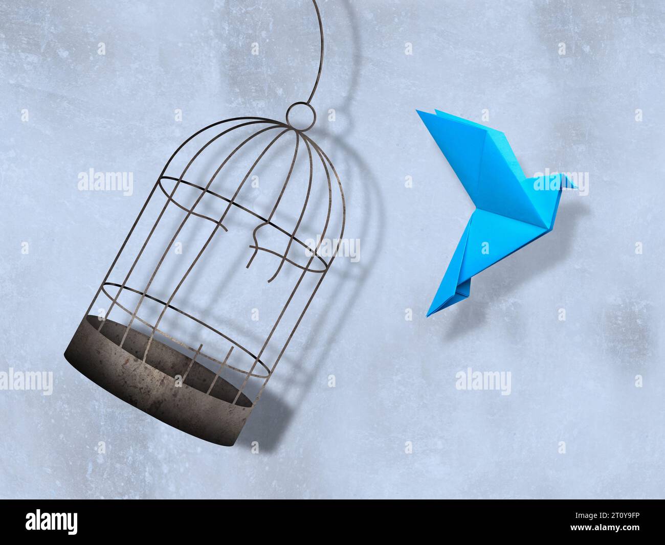 Freedom. Paper bird flying out of broken cage on light background Stock Photo