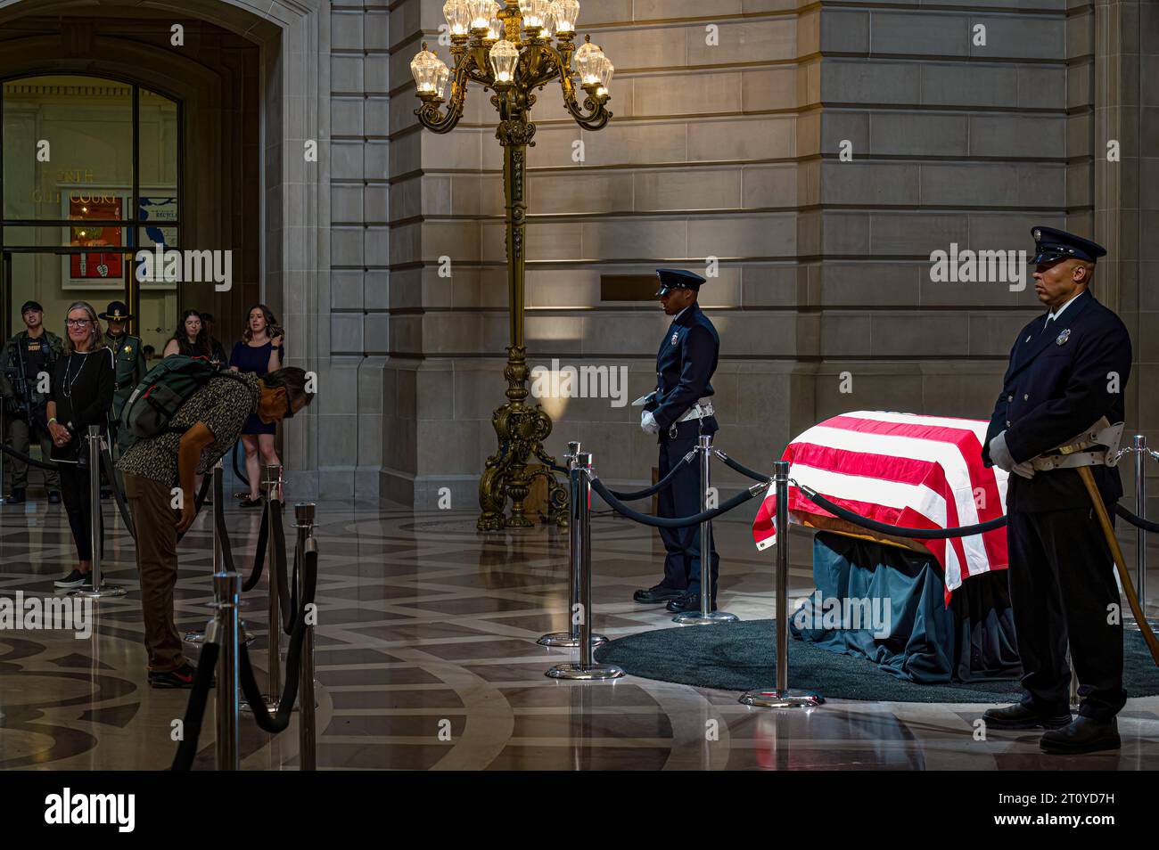 A man bows in respect while pausing in front of Senator Diane Feinstein's casket during the lying in state at City Hall. Stock Photo