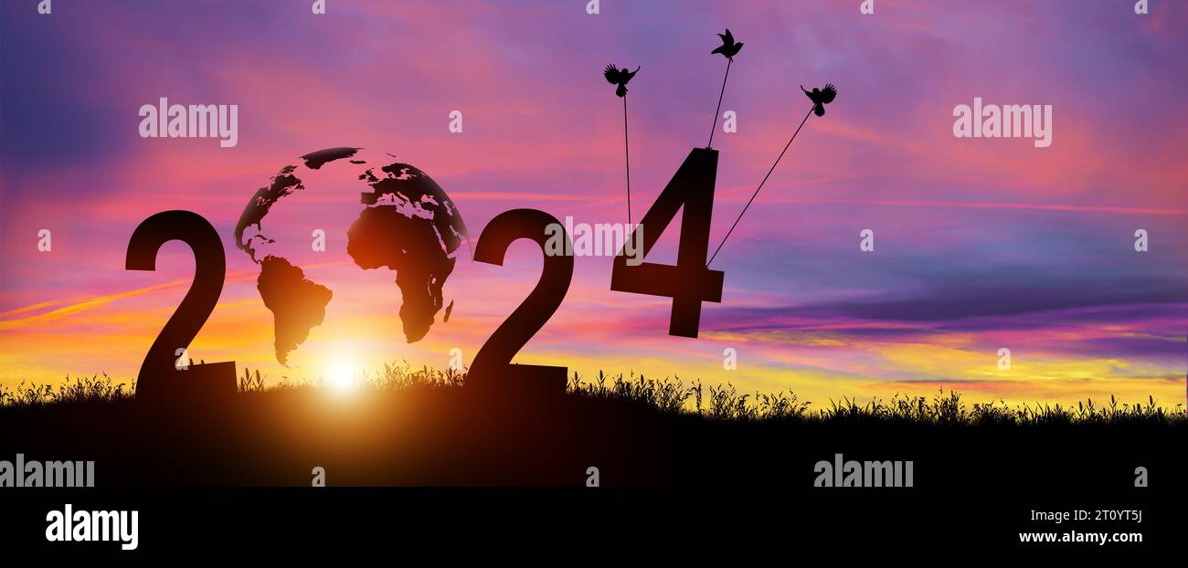 Silhouette 2024 years in sunset background. Birds carrying number 4 while celebrating 2024 years. Happy New Year and Merry Christmas. Copy space. Stock Photo