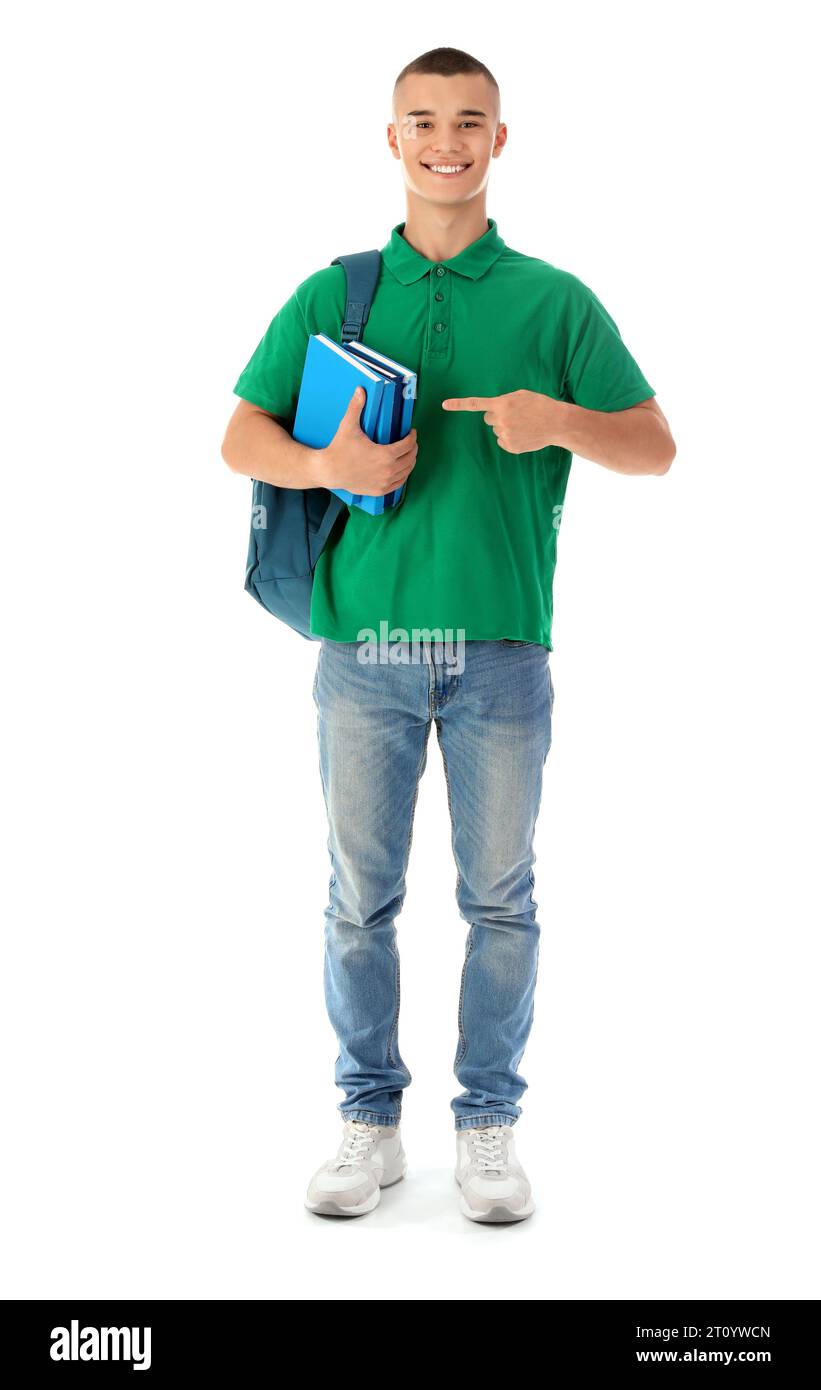 Happy male student with backpack pointing at books isolated on white ...
