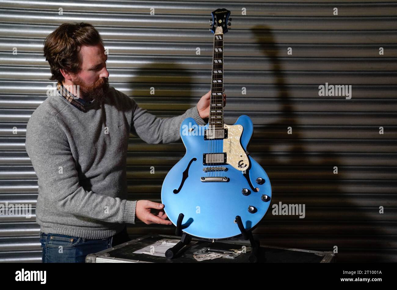 A Propstore employee holds Noel Gallagher s first prototype Epiphone Supernova guitar estimate 35 000 70 000 during