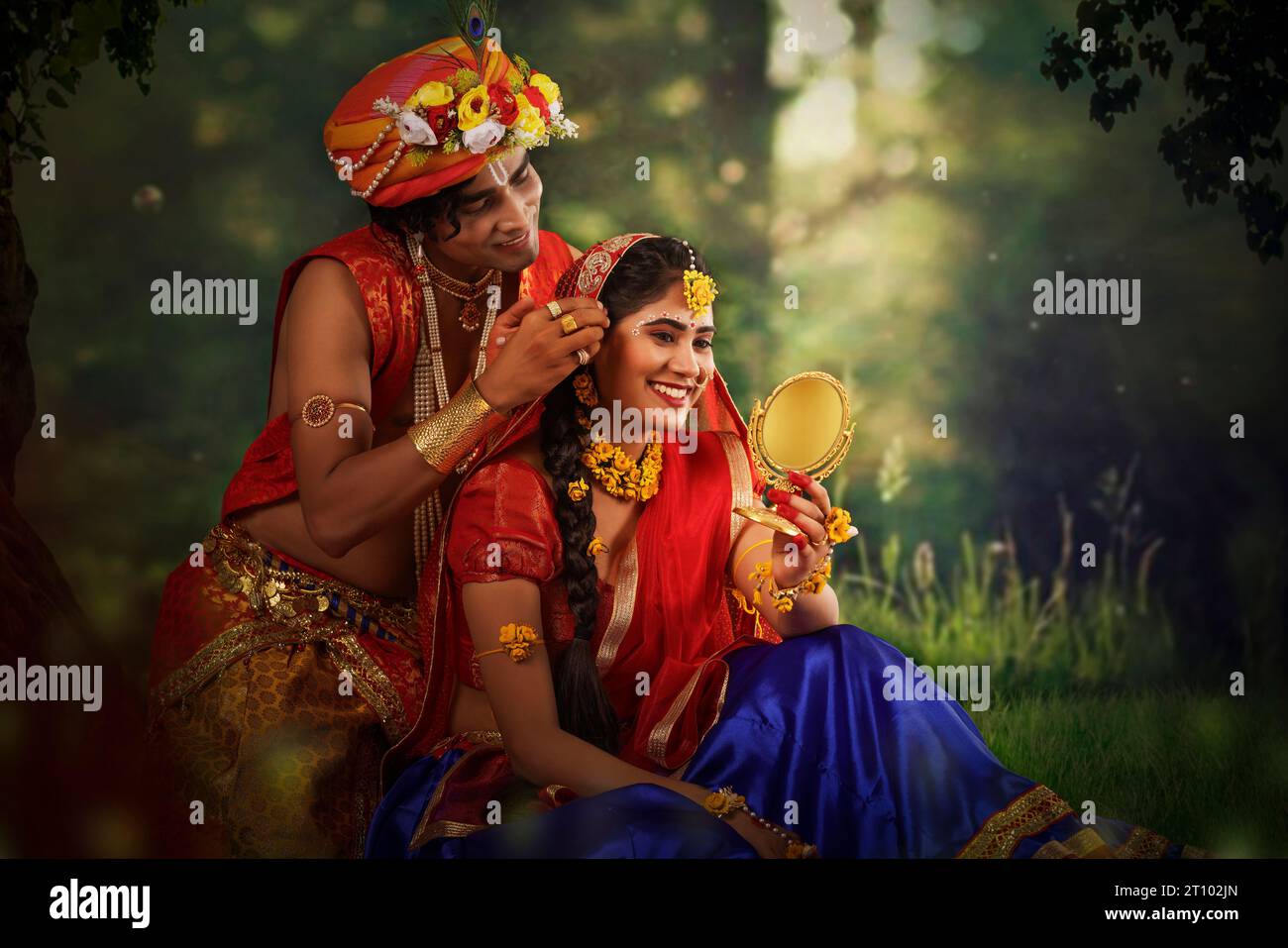 Young man and woman dressed up as Radha and Krishna and romancing on
