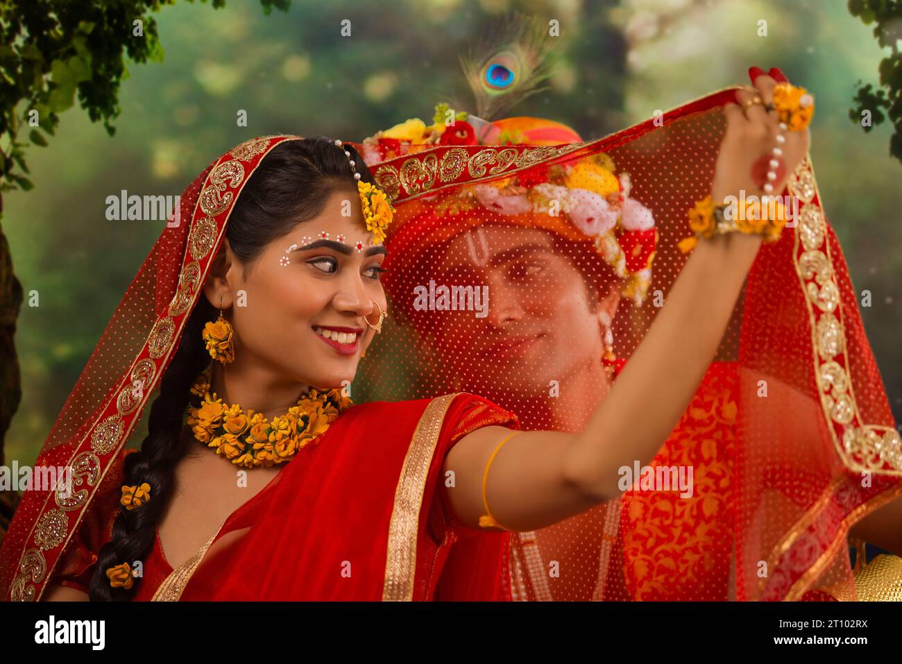 Young man and woman dressed up as Radha and Krishna and romancing on the occasion of Janmashtami Stock Photo