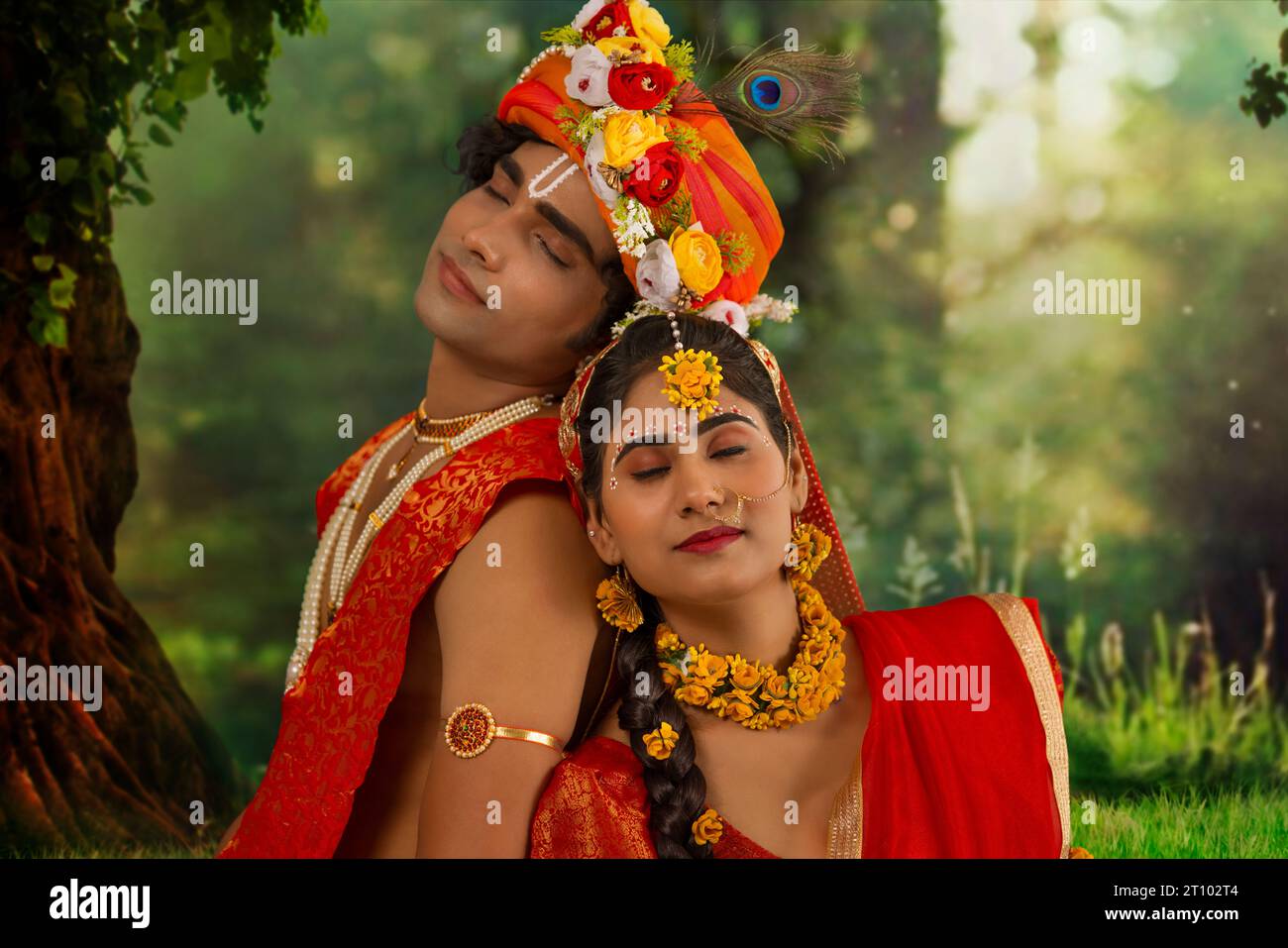 Young man and woman dressed up as Radha and Krishna and romancing on