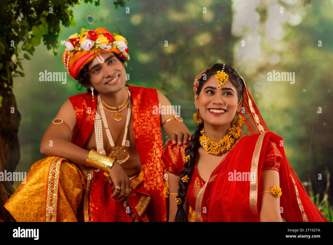 Young man and woman dressed up as Radha and Krishna and romancing on