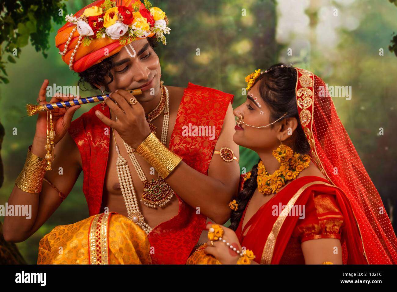 Young man and woman dressed up as Radha and Krishna and romancing on the occasion of Janmashtami Stock Photo