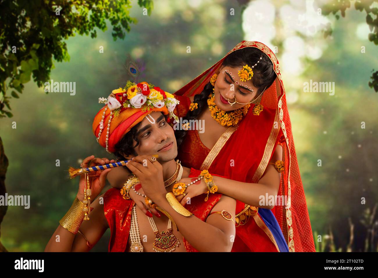 Young man and woman dressed up as Radha and Krishna and romancing on