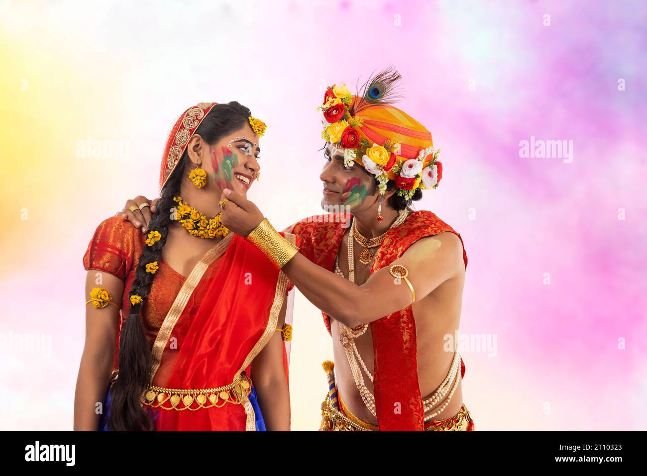 Young man and woman dressed up as Lord Radha and Krishna and playing Holi on the occasion of Janmashtami Stock Photo