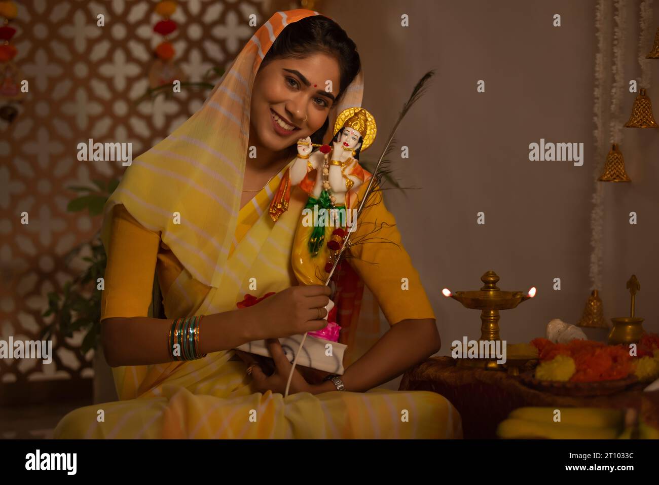 Woman celebrating Janmashtami at home Stock Photo