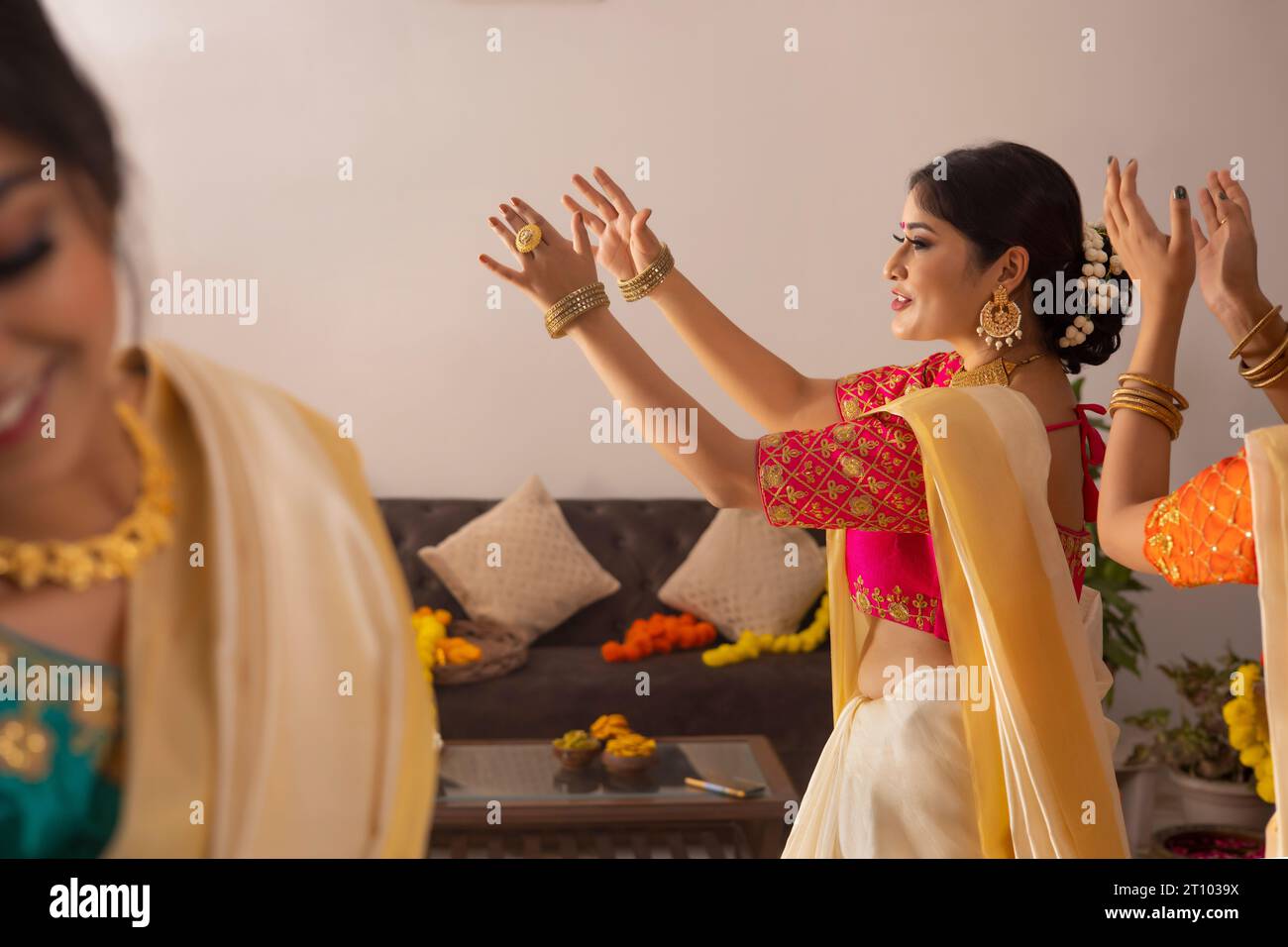 Women in white traditional outfit dancing on the occasion of Onam Stock Photo