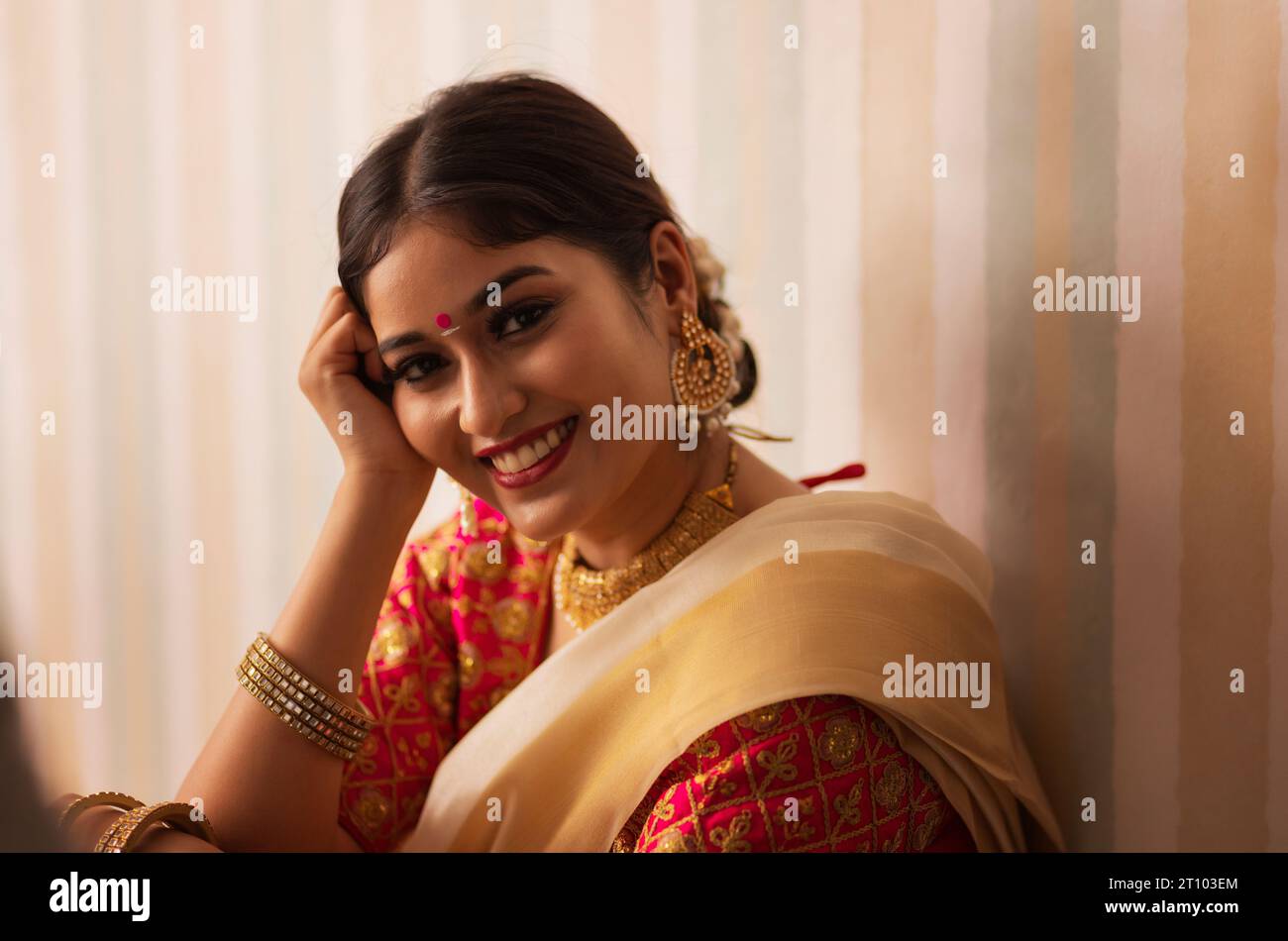 Close-up portrait of cheerful woman traditional outfit looking at camera Stock Photo