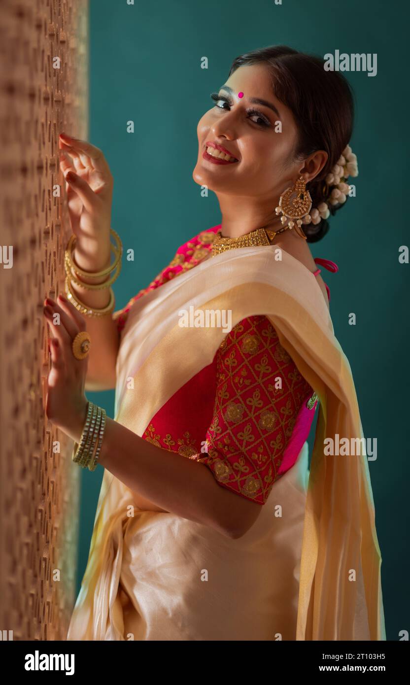 Portrait of cheerful woman in white saree looking at camera Stock Photo ...