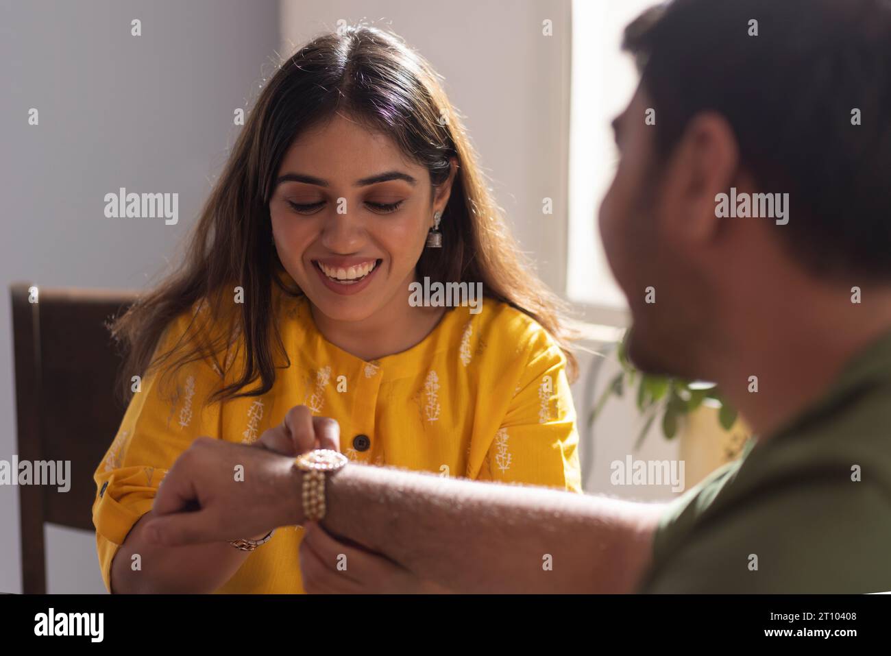 Sister tying Rakhi on her brother's wrist on the occasion of Raksha Bandhan Stock Photo