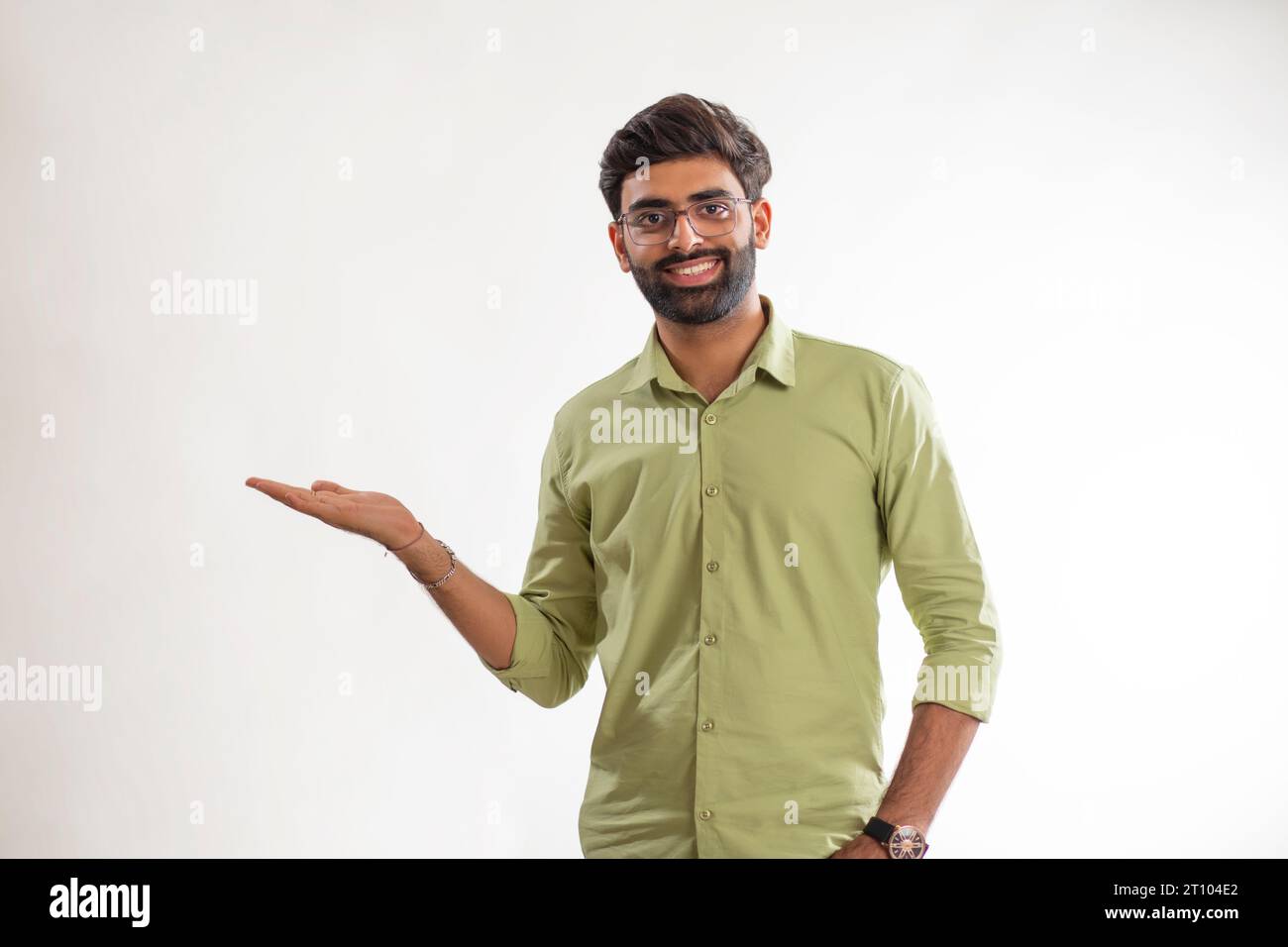 Portrait of a young man gesturing against white background Stock Photo