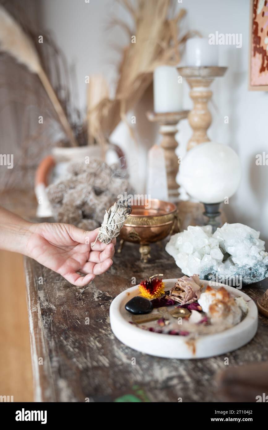 Top view of smudging sticks with dried flowers on a wooden tray Stock Photo