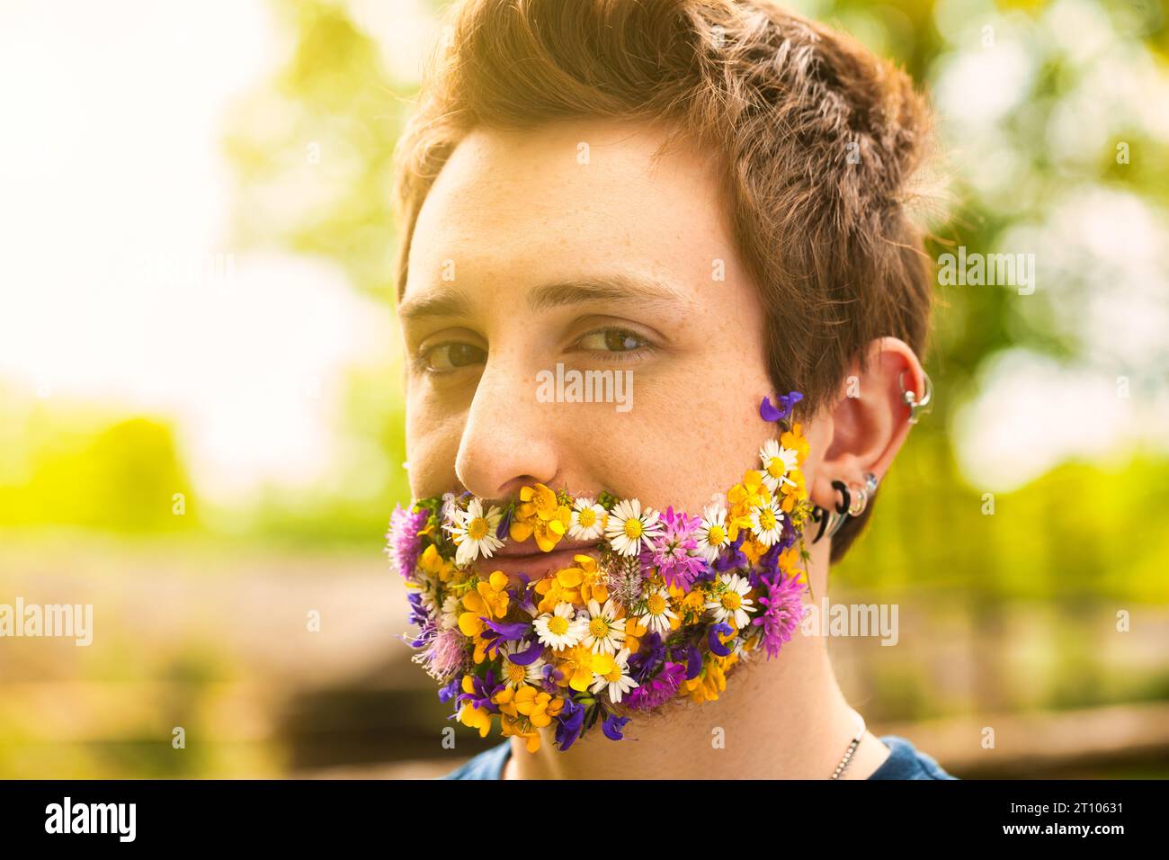 Among lush foliage, a man's unique trait shines: floral facial hair. This affinity, whether literal or symbolic, conveys his deep-rooted passion for t Stock Photo