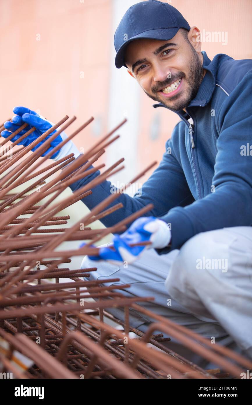 worker fixing steel rebar at building site Stock Photo