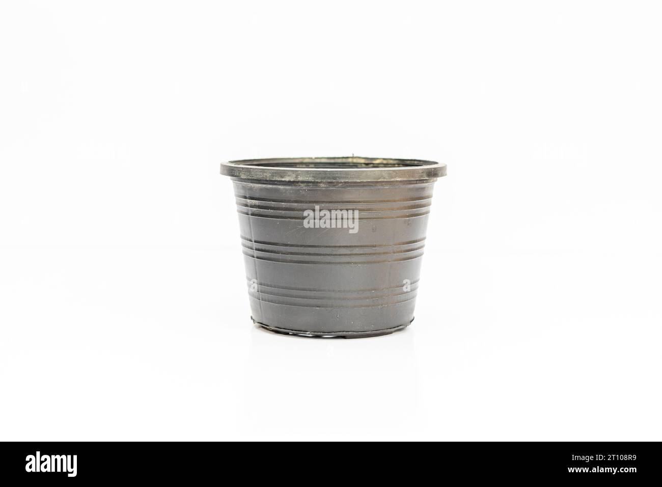 Black plastic flowerpot isolated on a white background Stock Photo - Alamy