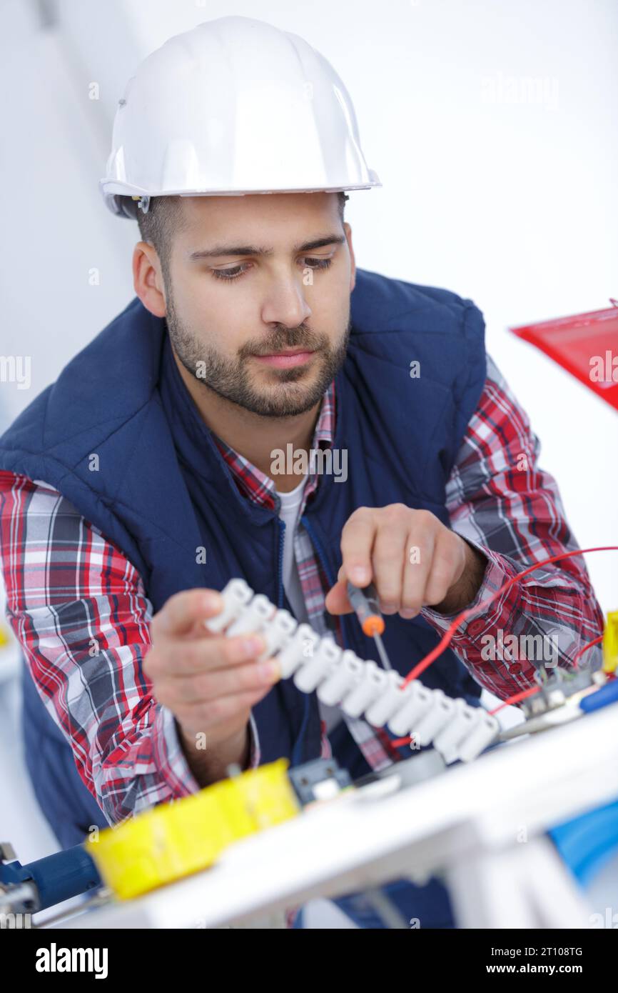 man at work testing wiring with a multi meter Stock Photo