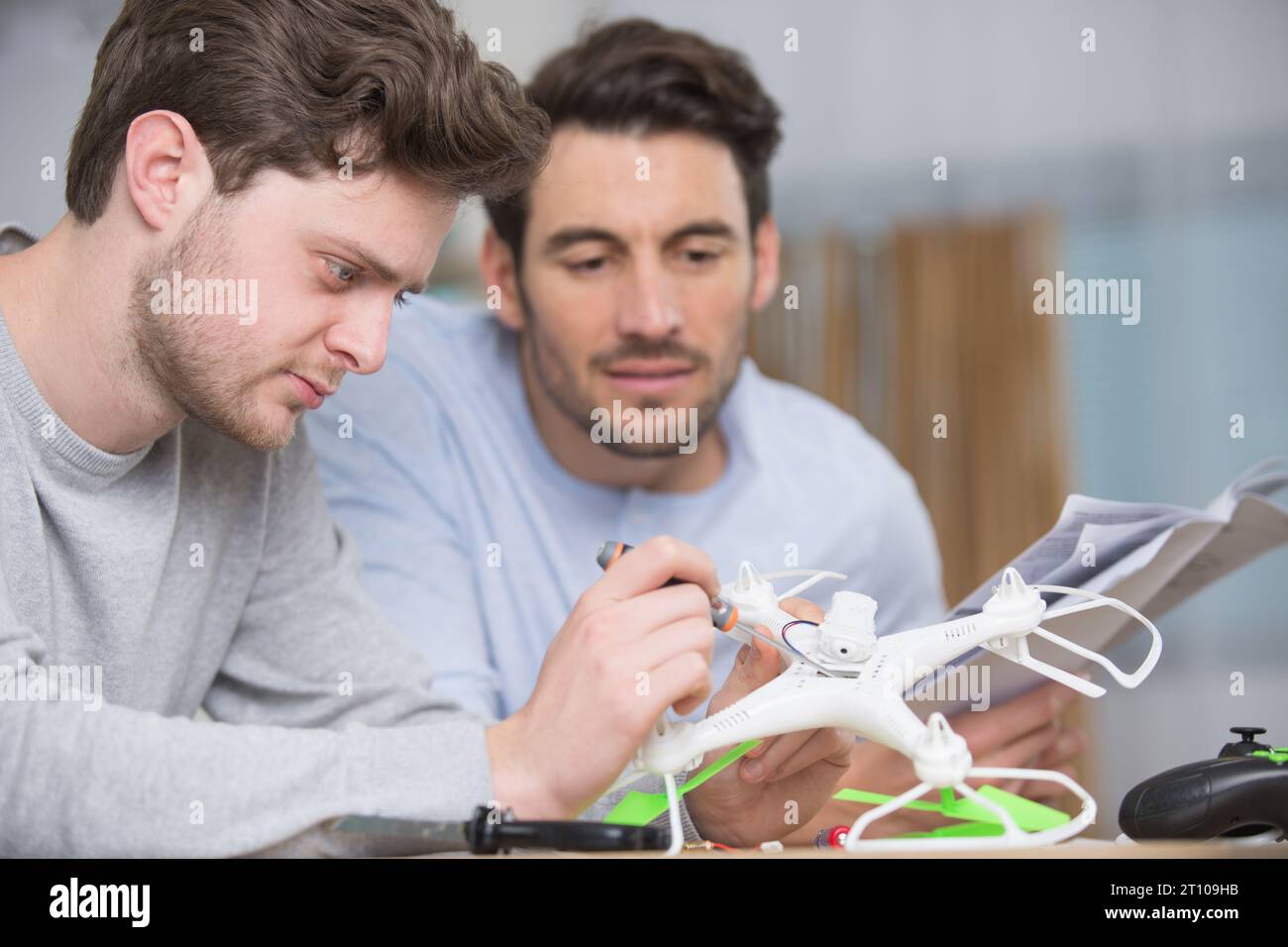 dad and son playing with toy drone Stock Photo - Alamy