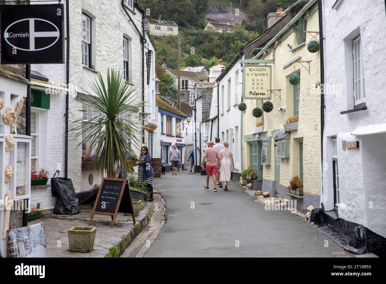 Polperro village in Cornwall, narrow street lane of village cottages and homes along with the Cornish flag standard,Cornwall,England,UK,2023 Stock Photo