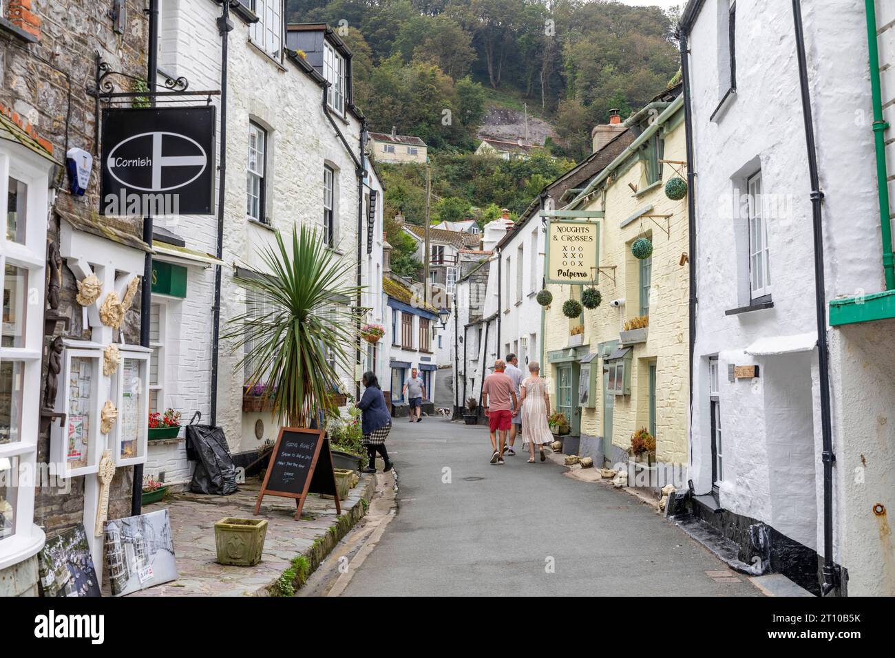 Polperro village in Cornwall, narrow street lane of village cottages and homes along with the Cornish flag standard,Cornwall,England,UK,2023 Stock Photo