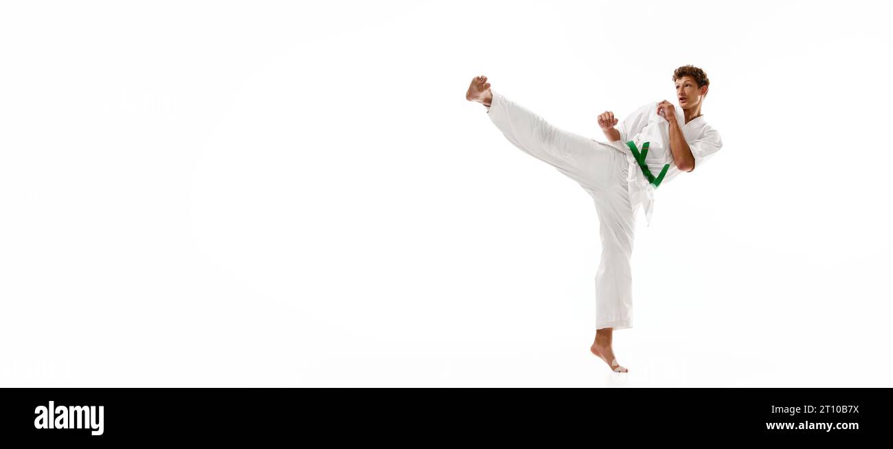 Young man, karate, taekwondo athlete in kimono and green belt training