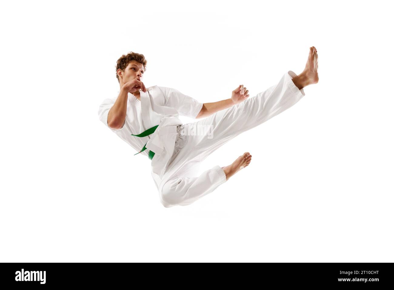Flying kicks. Professional martial arts athlete, karateka in white kimono training, practicing