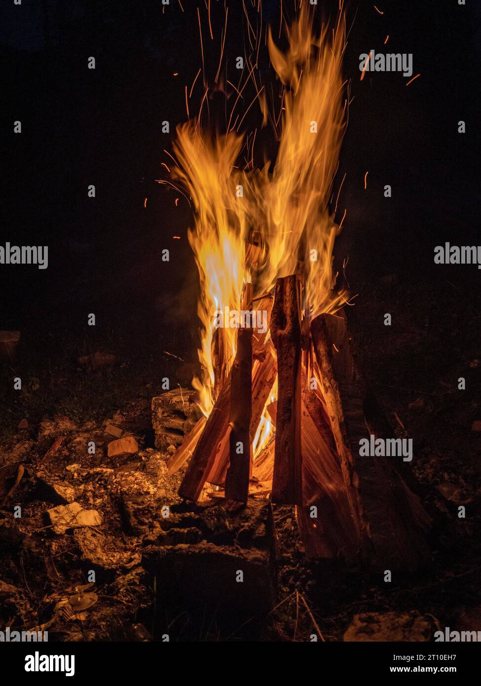 A vertical shot of a campfire burning at night Stock Photo - Alamy