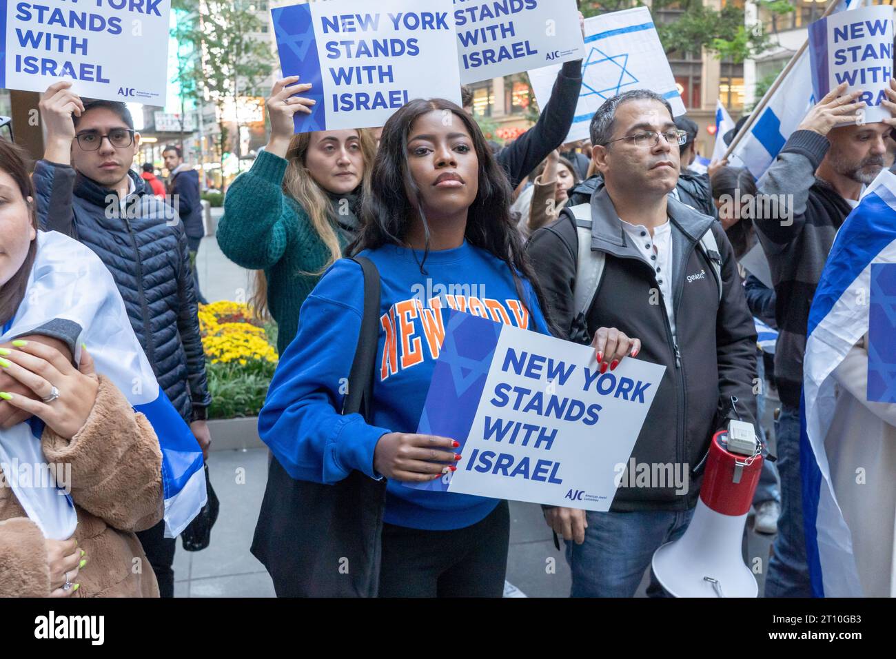 Supporters of Israel with Israeli flags, American flags and signs rally at a Candlelight Vigil for Victims of Terrorist Attacks in Israel at Manhattan's Golda Meir Square in New York City. On October 7, the Palestinian militant group Hamas launched a surprise attack on Israel from Gaza by land, sea, and air, killing over 900 people and wounding more than 2000. According to reports, 130 Israeli soldiers and civilians have also been kidnapped by Hamas and taken into Gaza. The attack prompted a declaration of war by Israeli Prime Minister Benjamin Netanyahu, and ongoing retaliatory strikes by Is Stock Photo