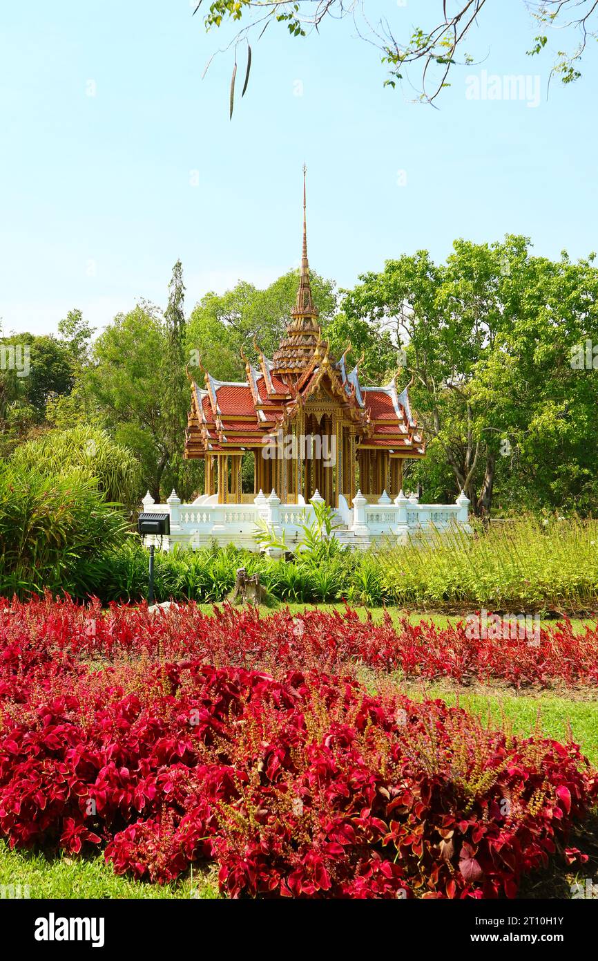 Gorgeous Thai Ancient Style Pavilion with Shrubs of Red Coleus in Foreground Stock Photo