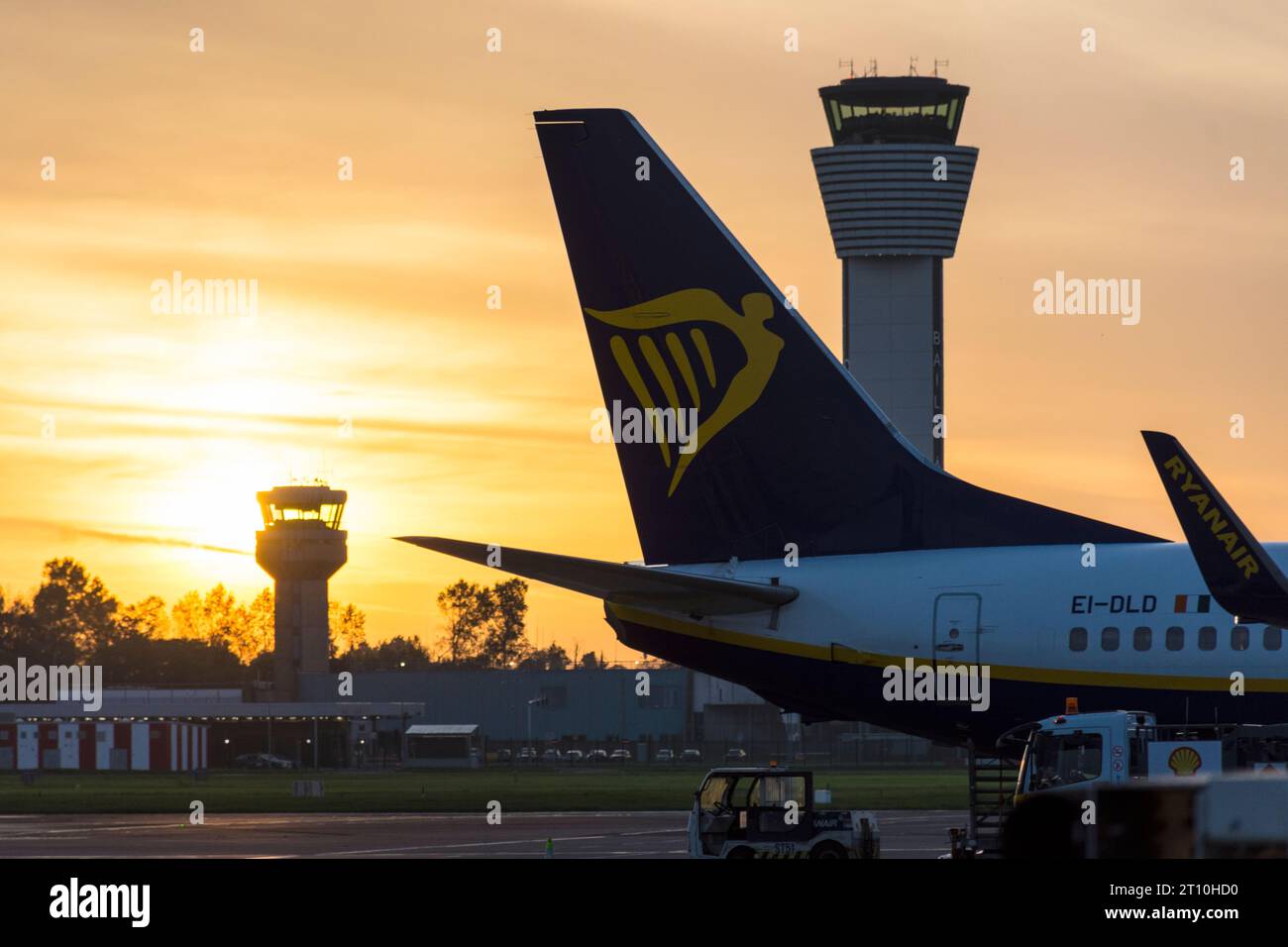 Dublin Airport, Ireland, sunset and control towers and aircraft on stand. Stock Photo