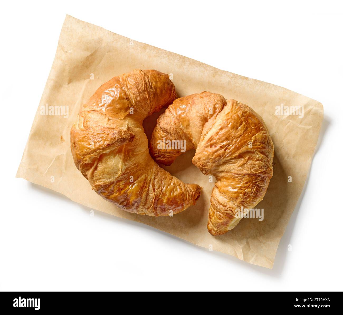 freshly baked croissants on baking paper isolated on white background, top view Stock Photo