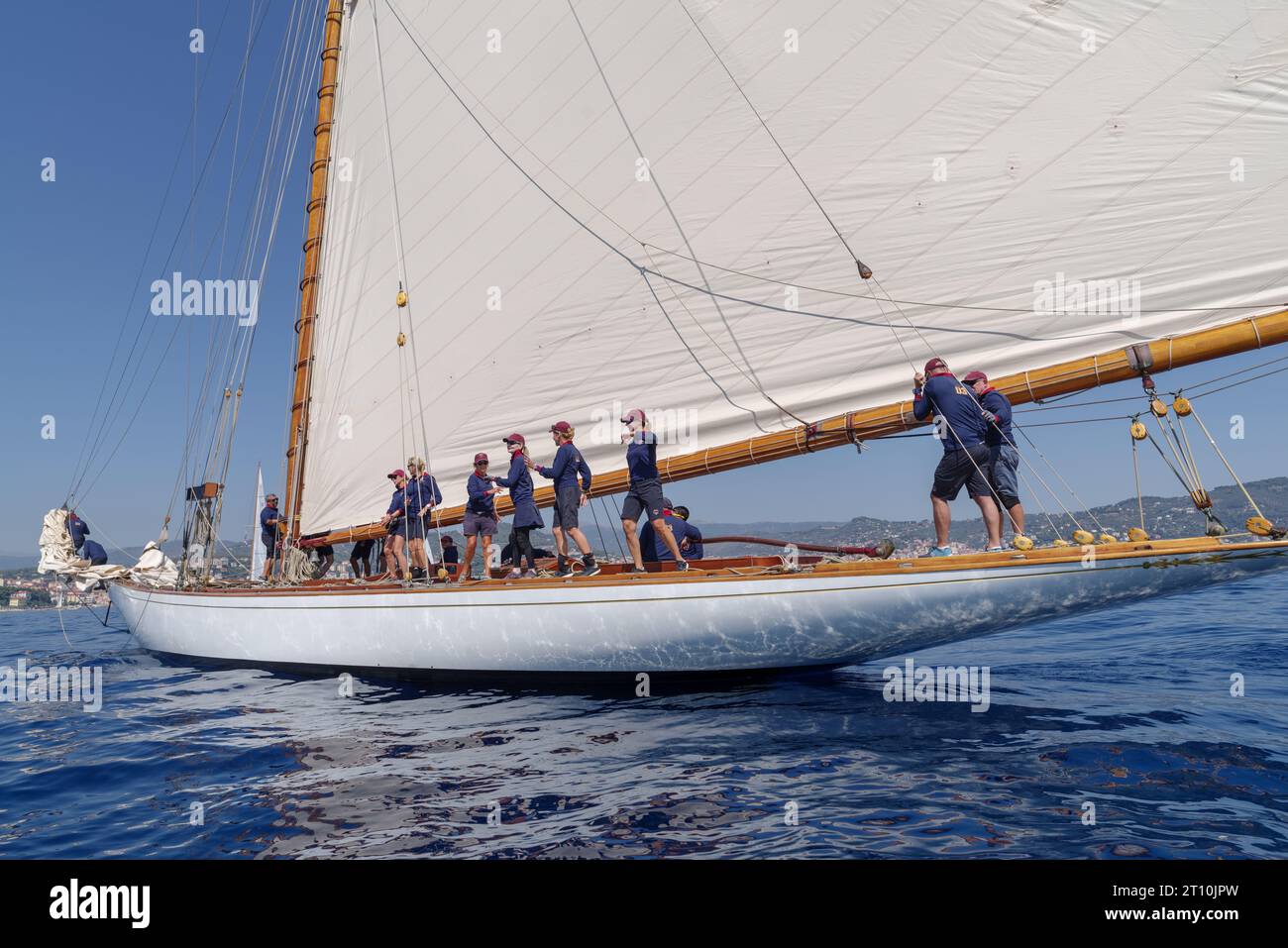 Crew members aboard on sailboat Tuiga, flagship of the Monaco Yacht Club, during racing in Gulf of Imperia, Italy Stock Photo