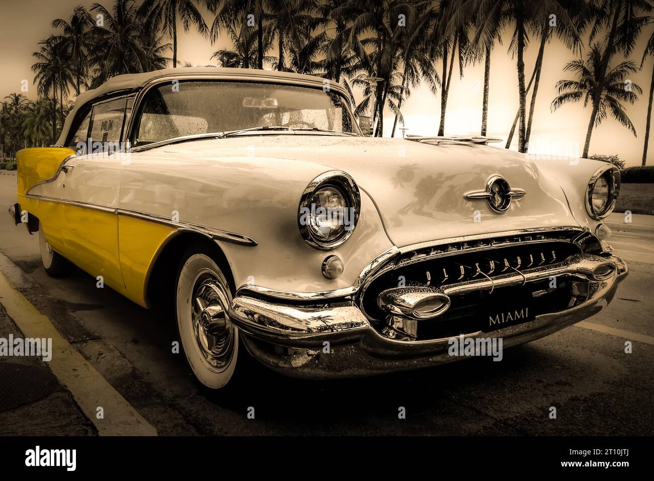 Oldsmobile 88 Automobile, two-door holiday coupe, circa 1955, yellow & cream, Ocean Drive. Miami Beach Stock Photo