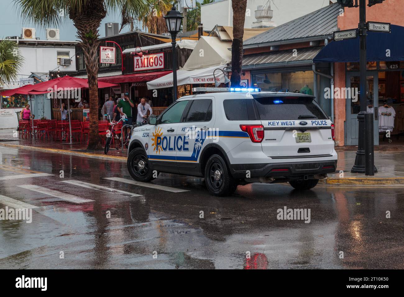 The Key West Police Cruiser. Duval Street, Florida, USA, on a wet and stormy day, responding to an emergency call Stock Photo