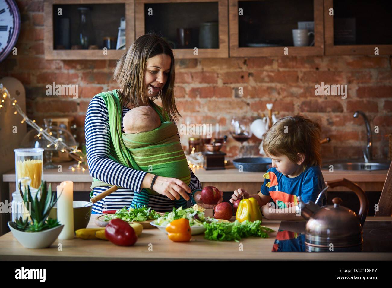 Young family, mother with two children, adorable preschool boy and baby ...