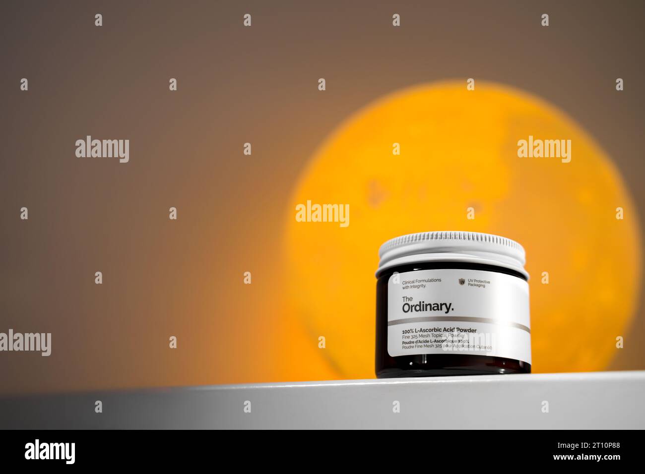 Strasbourg, France - September 2023: The Ordinary skincare brand by Deciem. Vitamin C in L-Ascorbic Acid powder form packaging against an Orange moon. Stock Photo