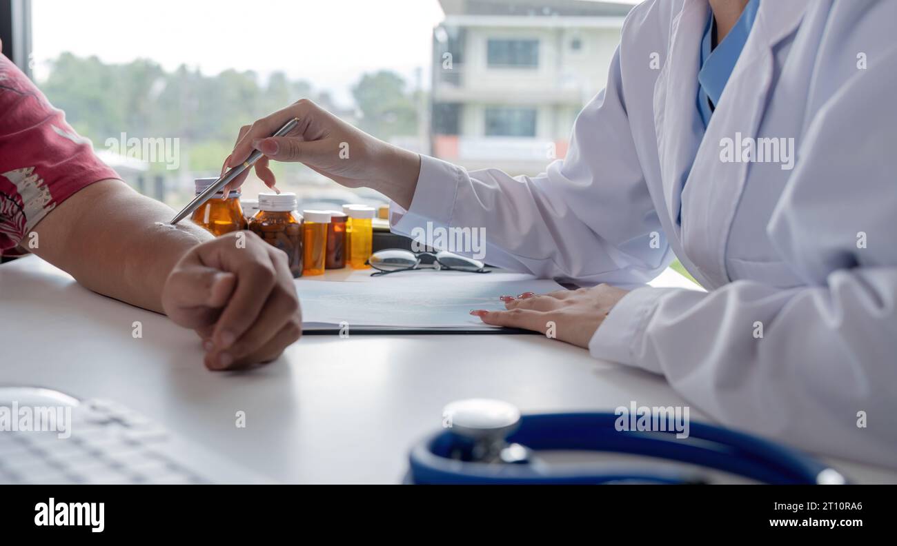 Physician discuss results or symptoms and gives a to a male patient and signs a