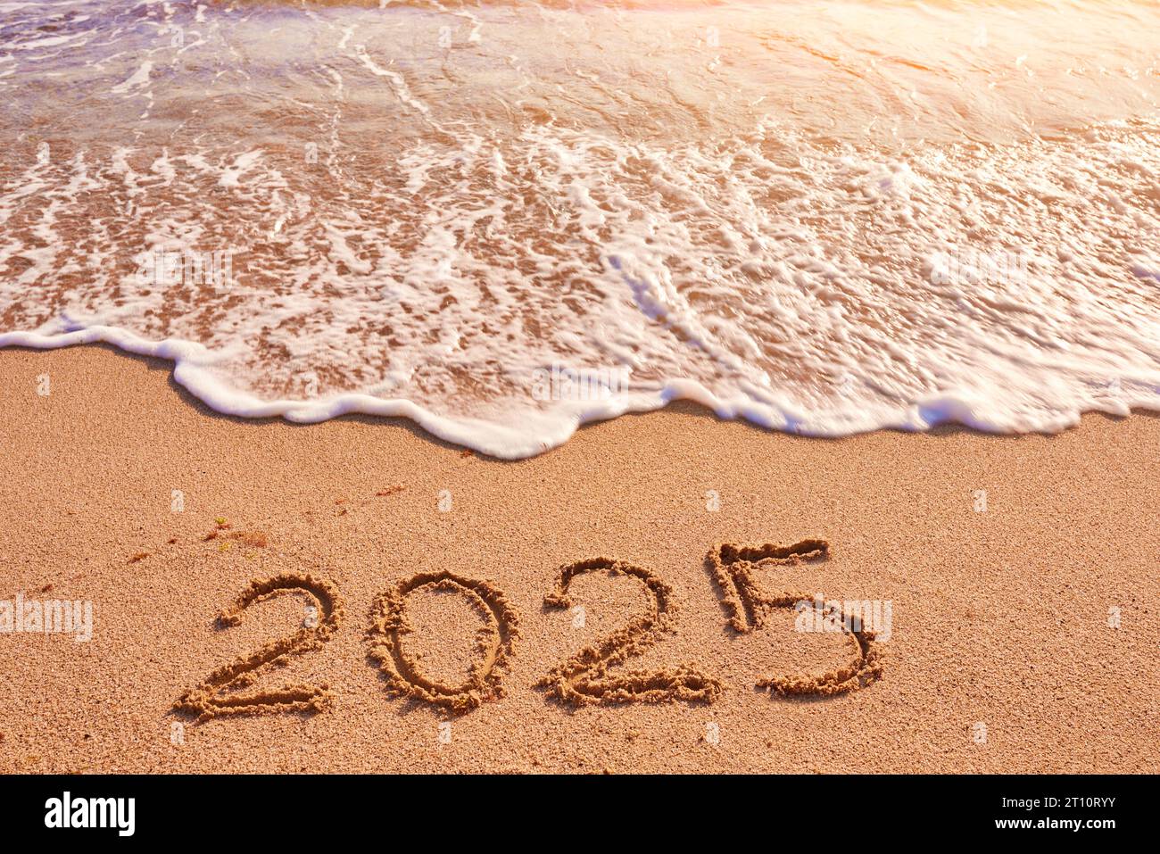 2025 year drawing on sandy beach sea at sunny day Stock Photo Alamy