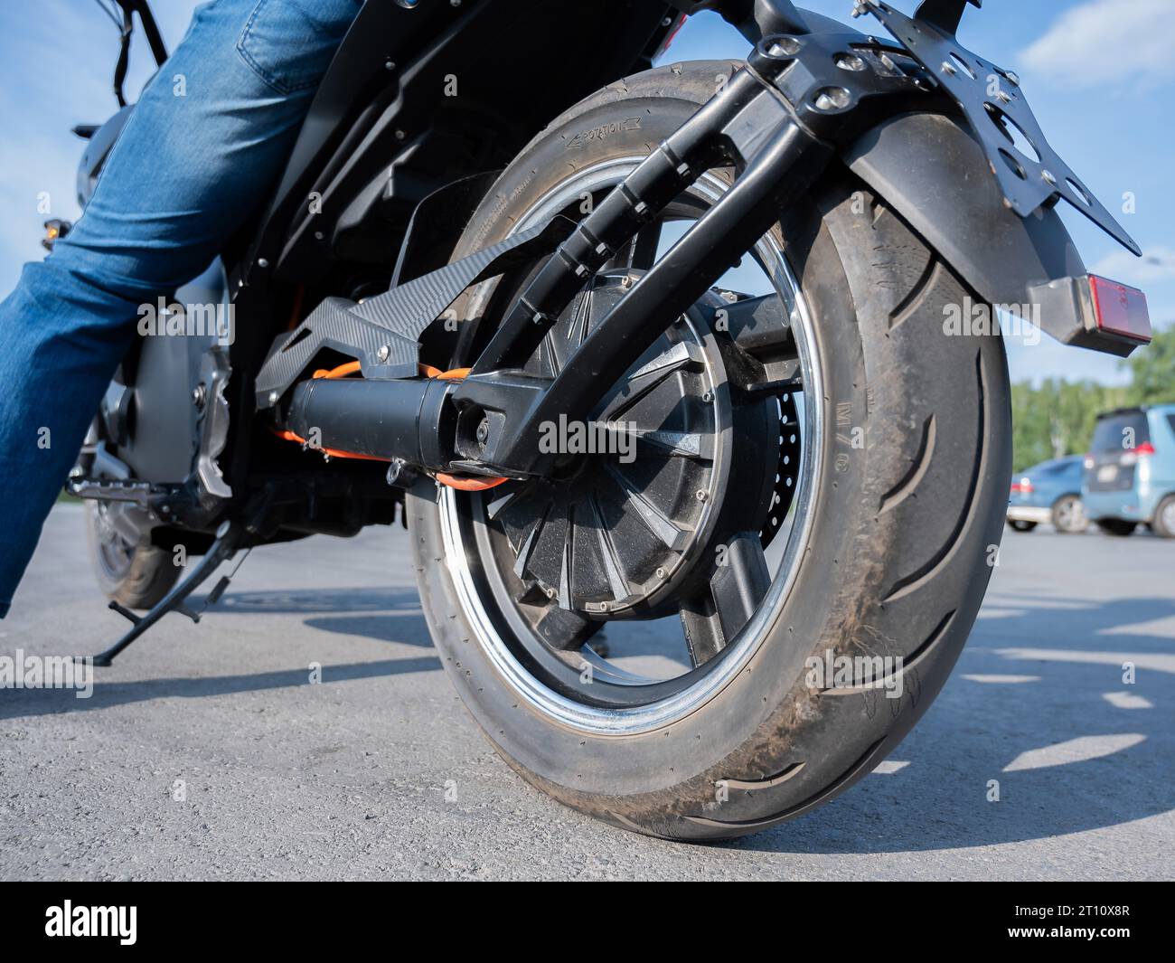Close-up of the rear wheel with the engine of an electric motorcycle ...