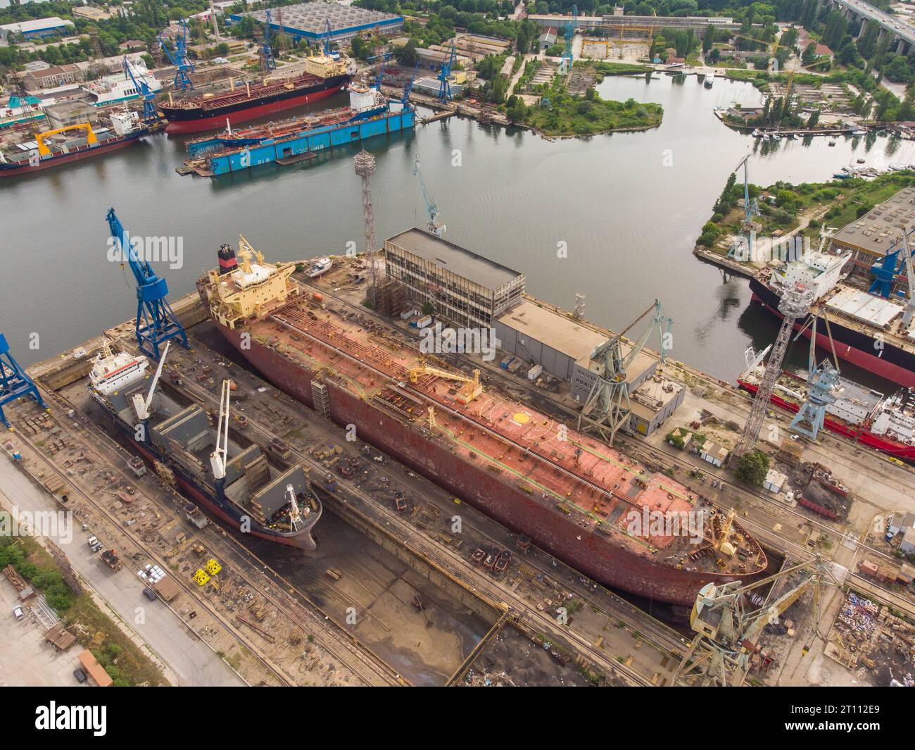 Tanker vessel repair in dry dock Shipyard, aerial top view Stock Photo