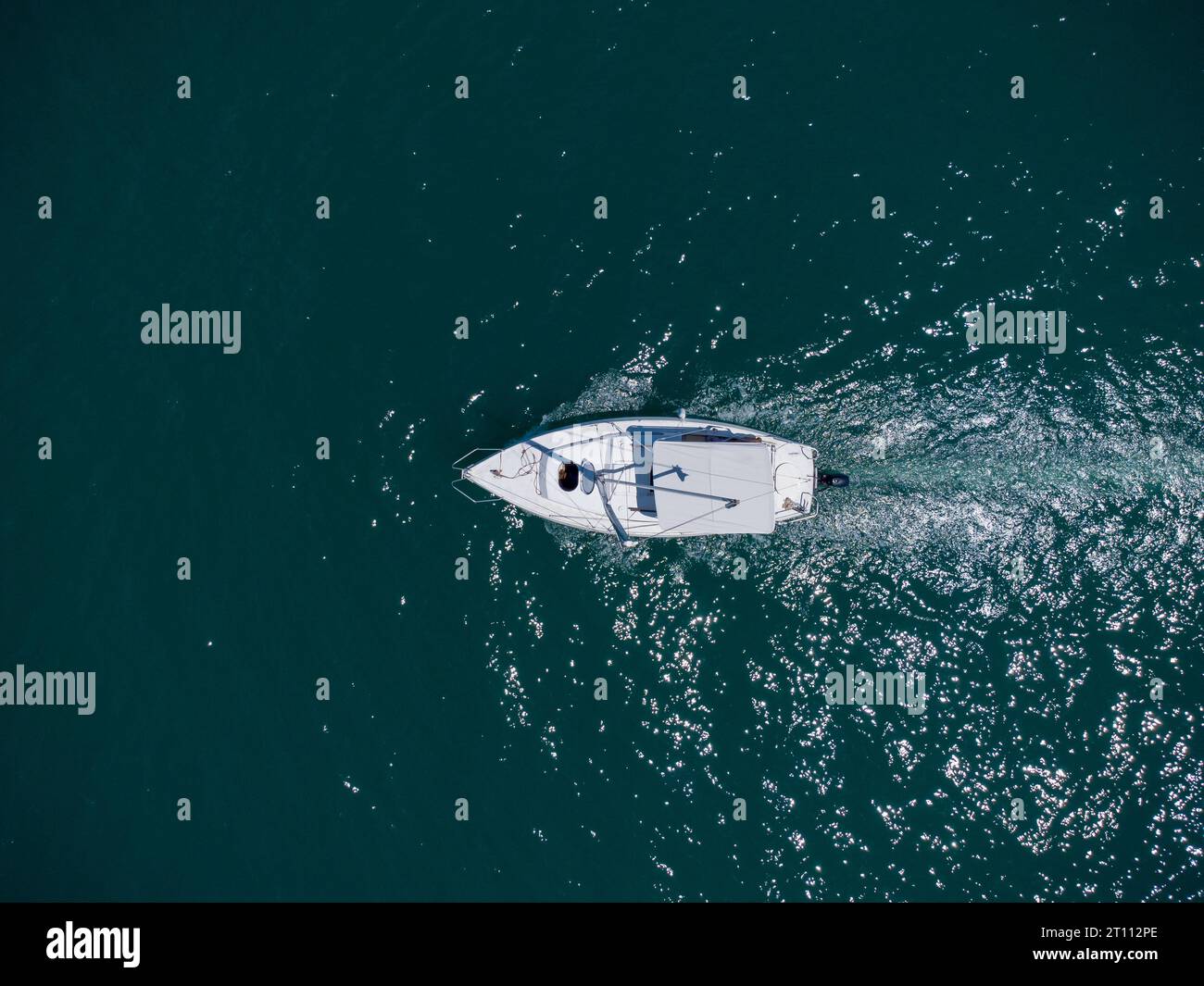 Aerial top down view of white speed motor boat on open sea at summer ...