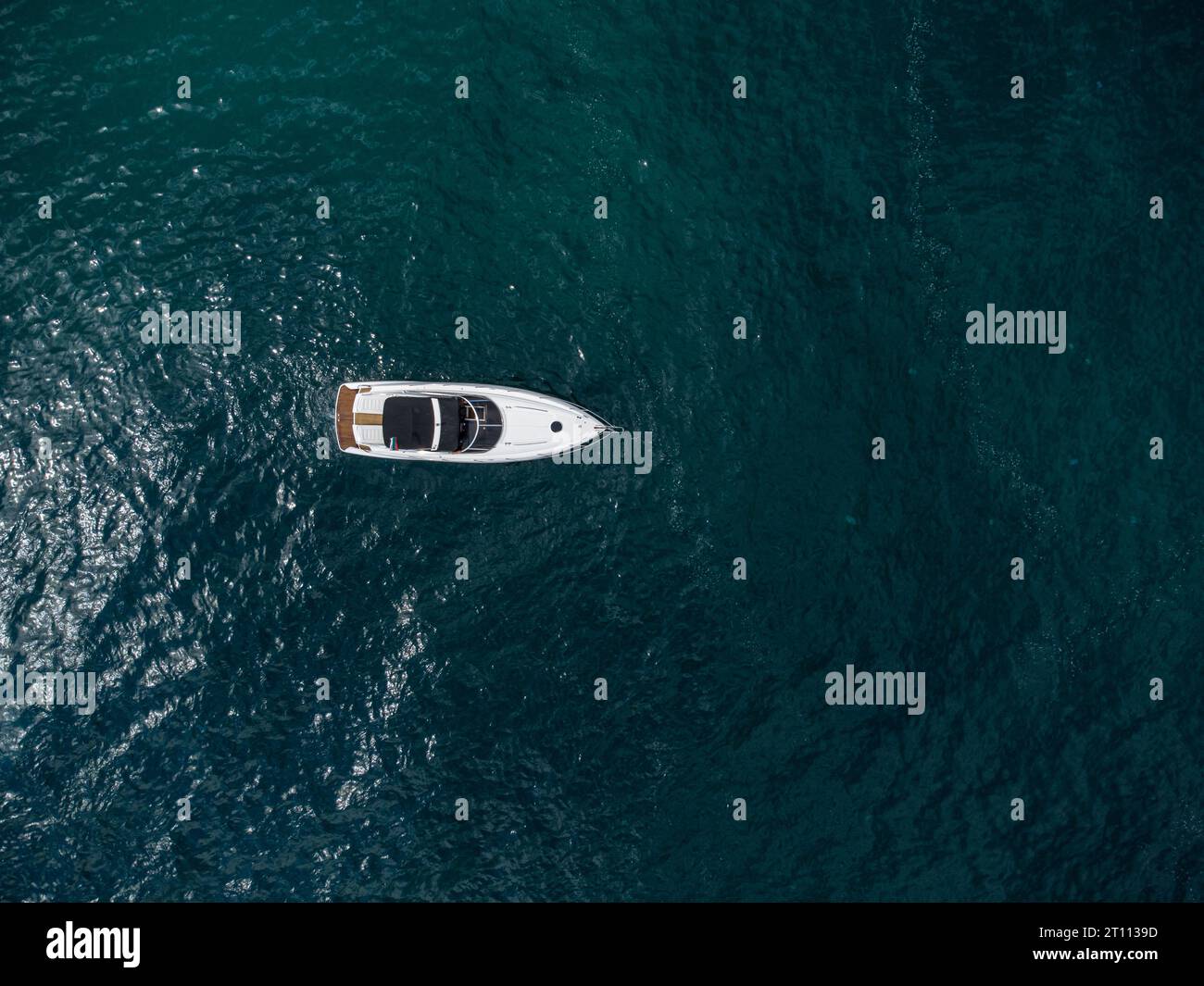 Aerial top down view of speed motor boat on open blue sea Stock Photo ...