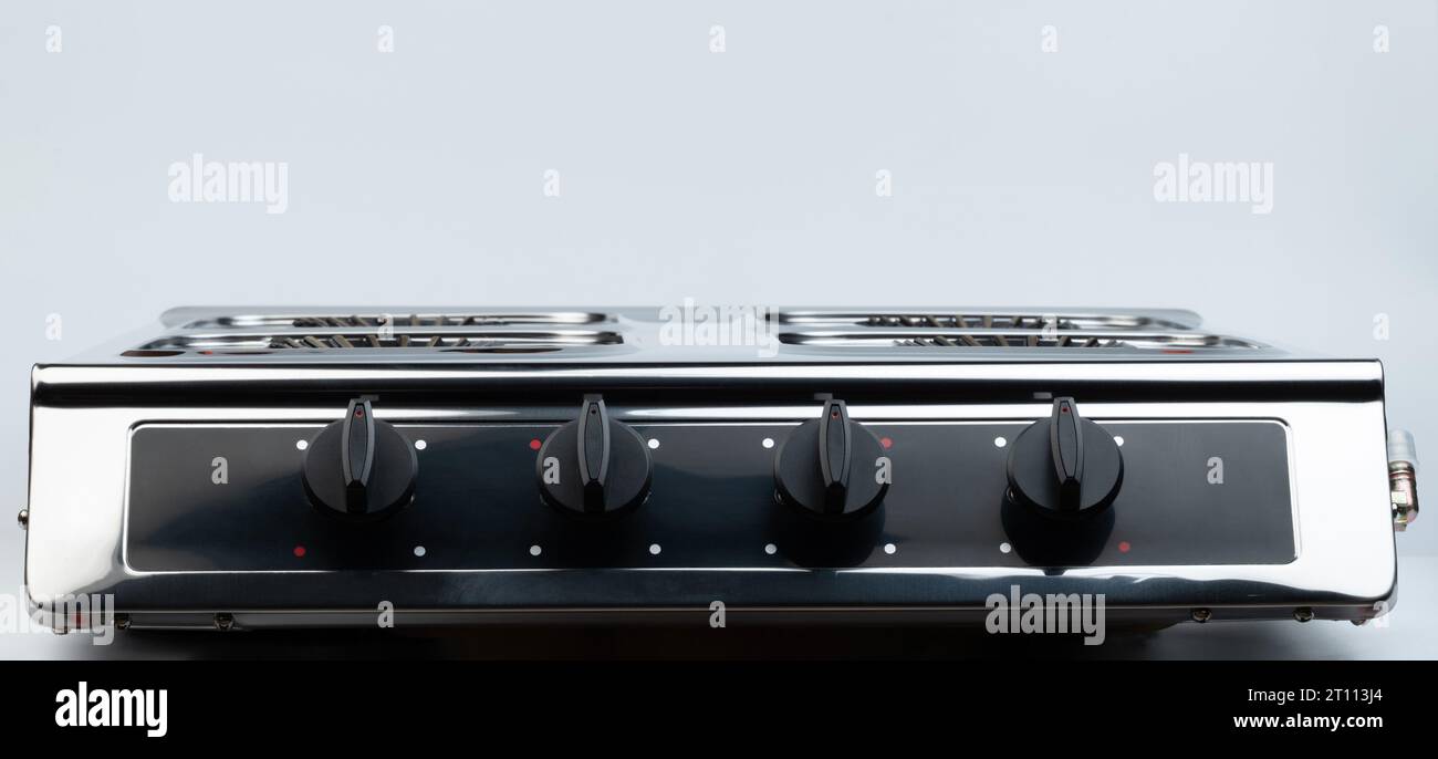 Gas stove with black knobs front view isolated on studio background