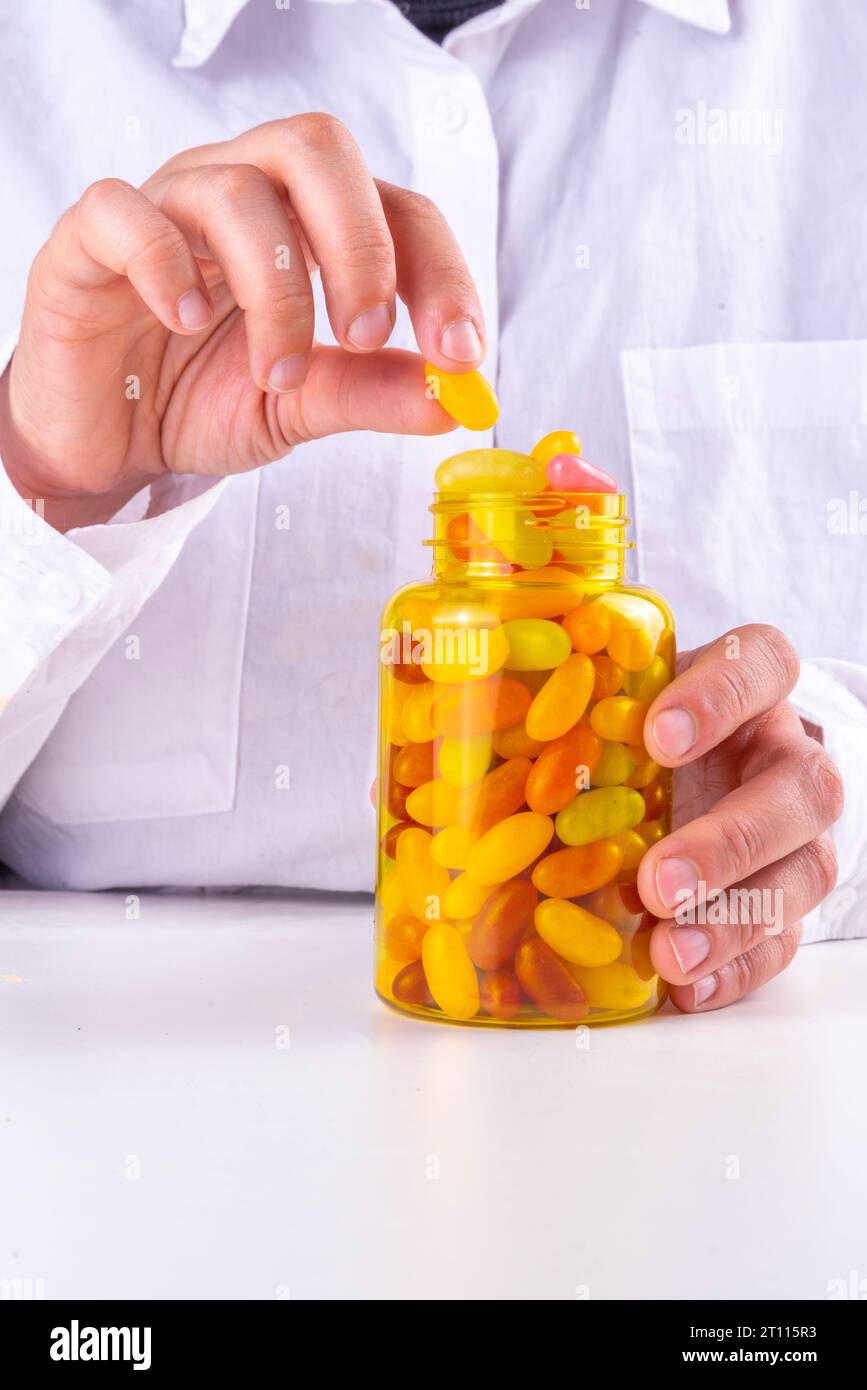 Gummy Vitamins and supplement for adults. Woman eats sweet jelly multivitamin candy